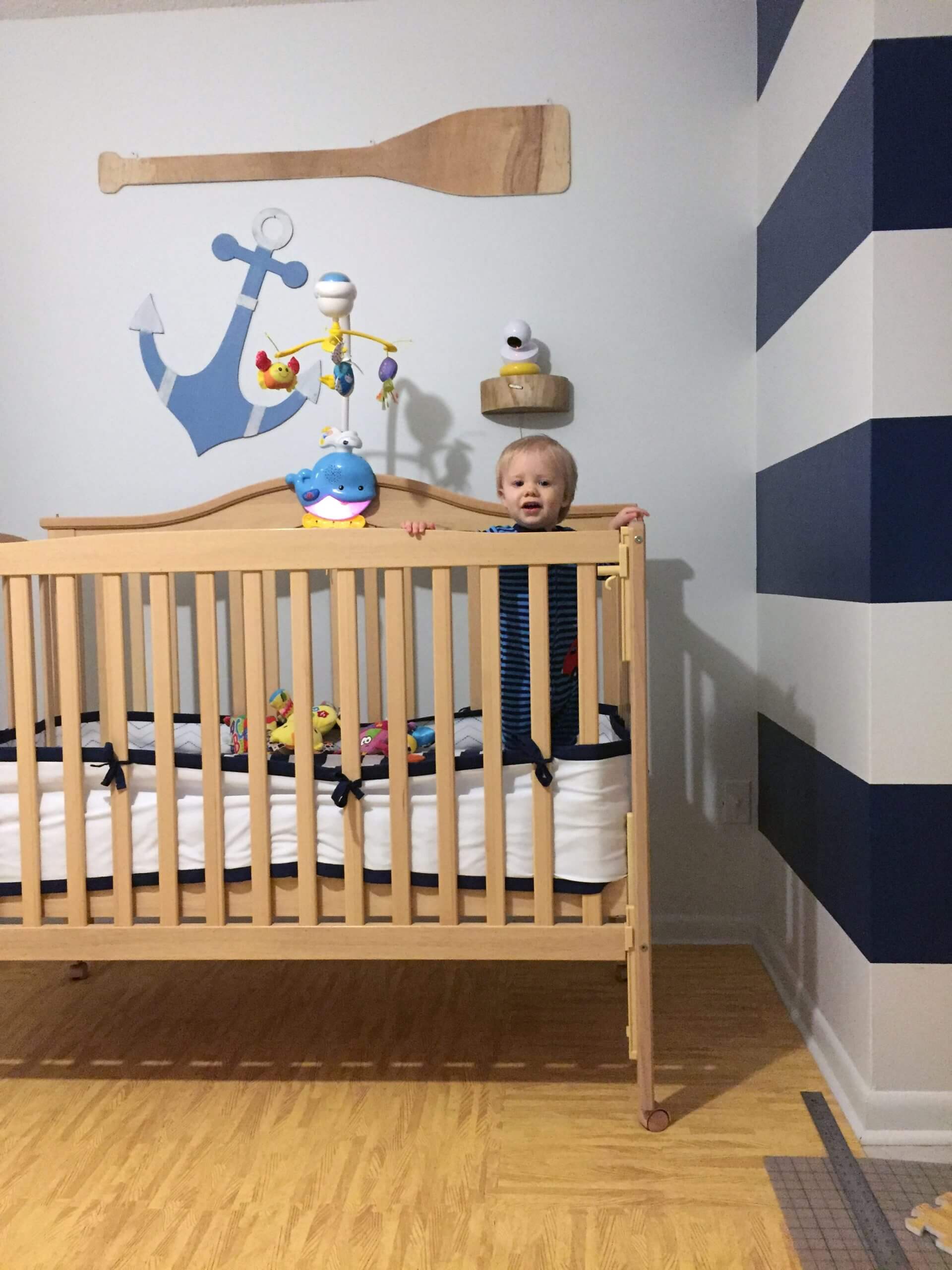 Custom theme baby room updated with foam flooring, wall stripes, and handmade decorations