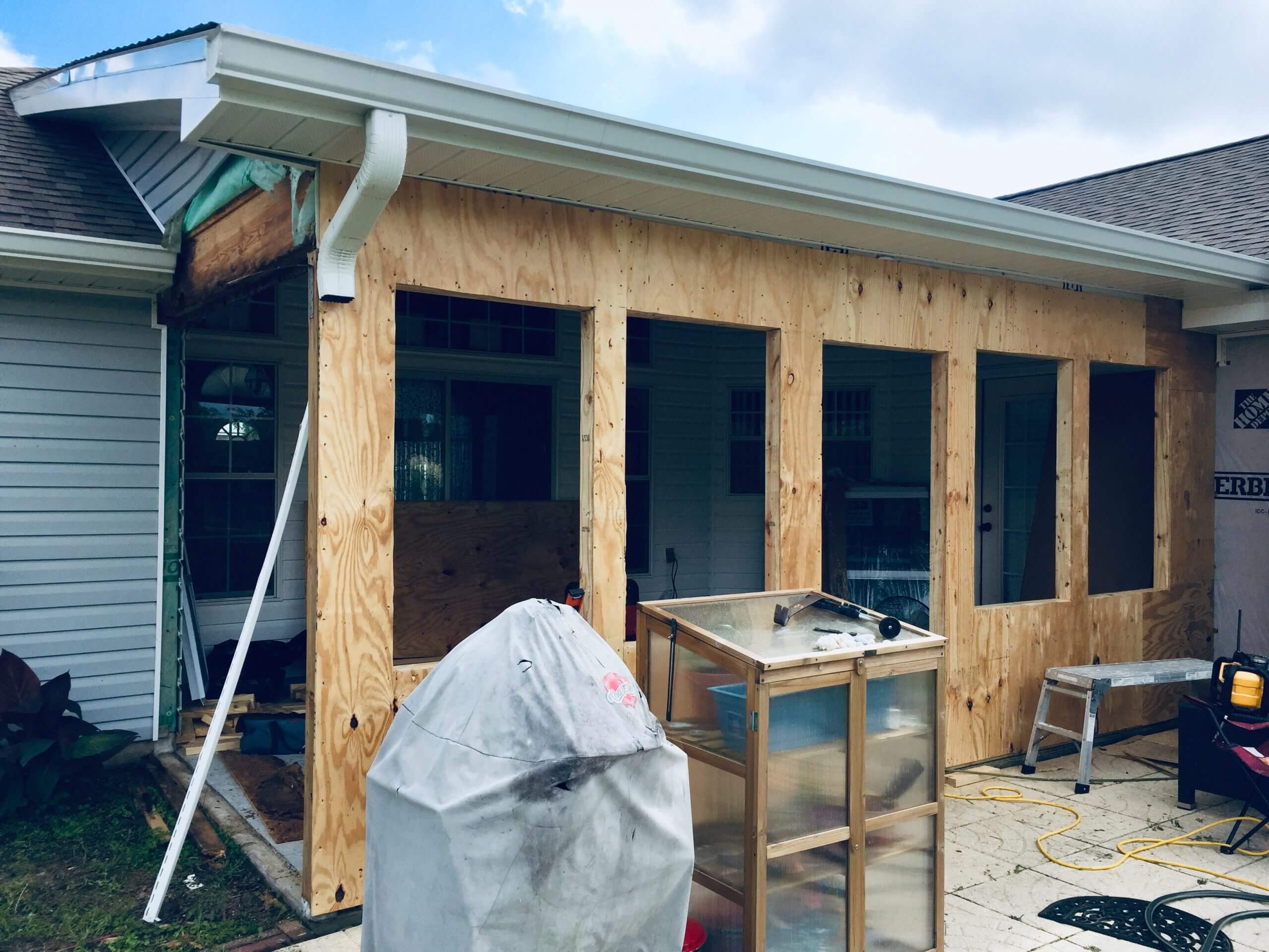 Covered back patio enclosure renovation progress shown from the outside