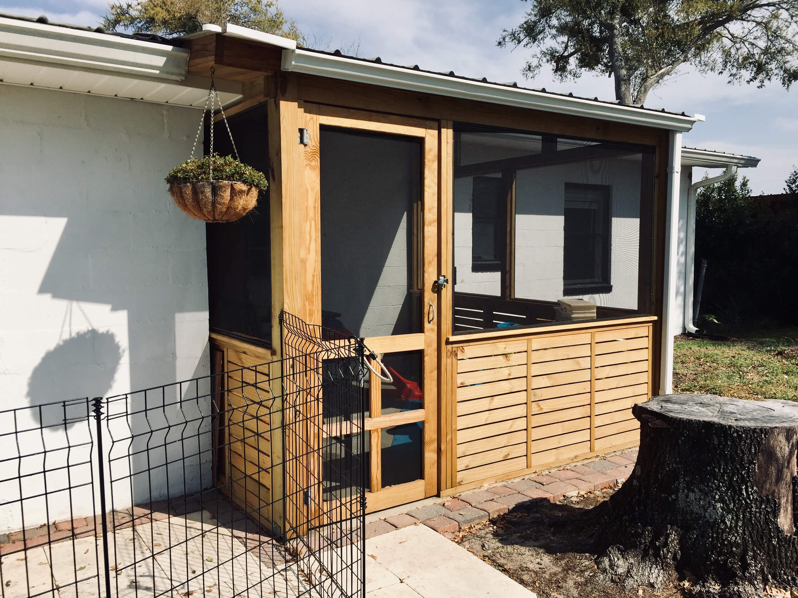 Enclosed screen back patio with wooden slats outside view
